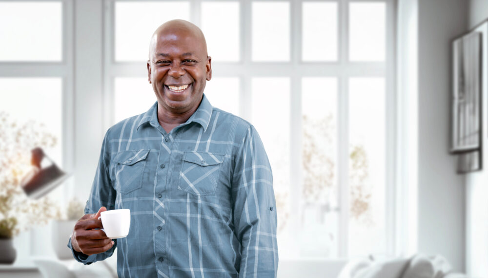 Happy Mature Black Man Drinking Coffee while relaxing